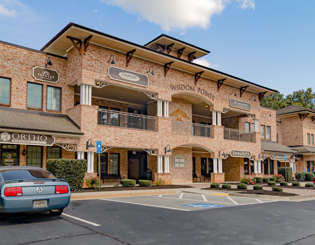 Street-level view of the Wisdom Pointe Village brick façade and storefronts