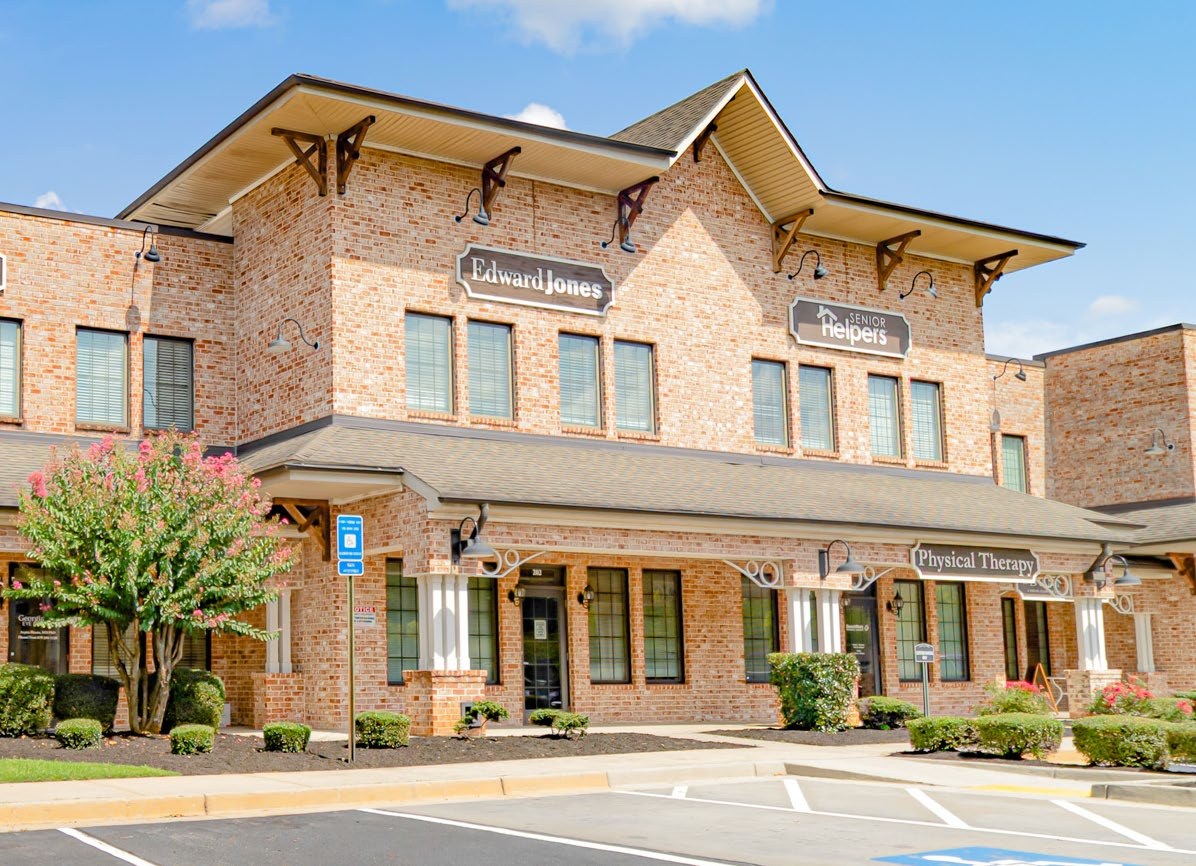 Front entry of Wisdom Pointe Village with tenant storefront signage