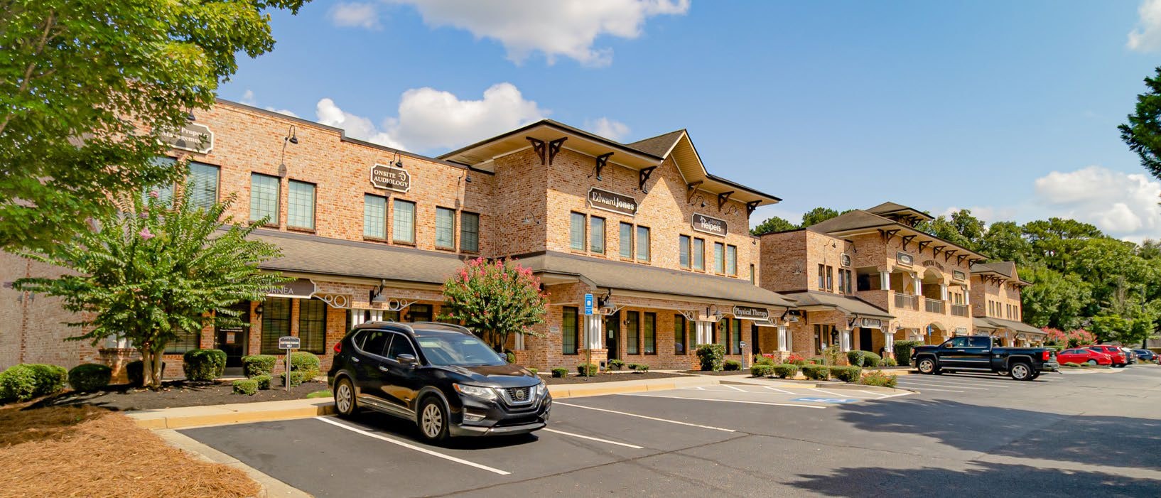 Brick façade and covered walkway along the storefronts